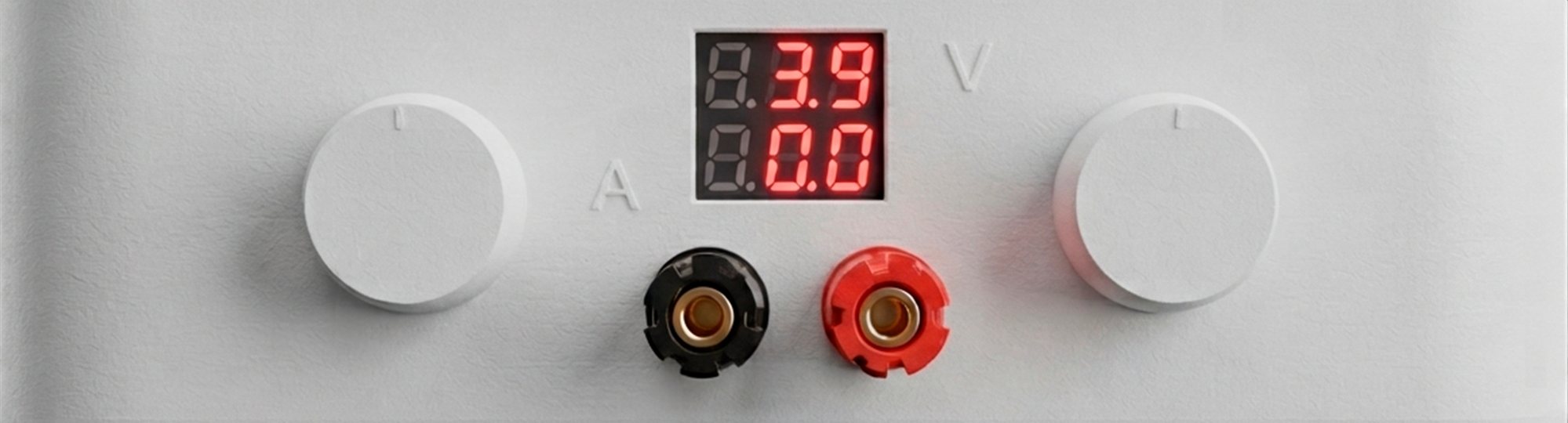 Close-up of the MagBatt front panel: handles, voltage and current readout, terminals